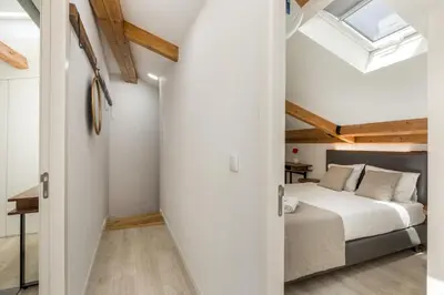 a bedroom with a bed and a skylight at Bra.com Apartments Oporto Faria Guimarães in Porto