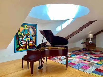 a piano in a living room with a painting at Spacious Apartment in Porto with Terrace in Porto