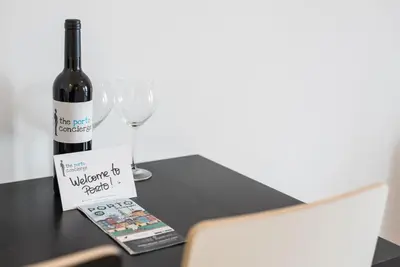 a bottle of wine sitting on a table with a glass at GuestReady - Music Flats 2 in Porto