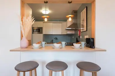a kitchen with two stools and a counter top at Cardosas Palace Apartment in Porto