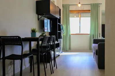 a living room with a dining room table and chairs at Bonsai Apartment I in Porto