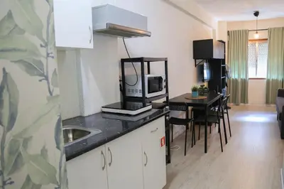 a kitchen with a counter top with a microwave at Bonsai Apartment I in Porto