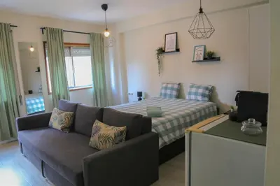 a living room with a couch and a bed at Bonsai Apartment I in Porto