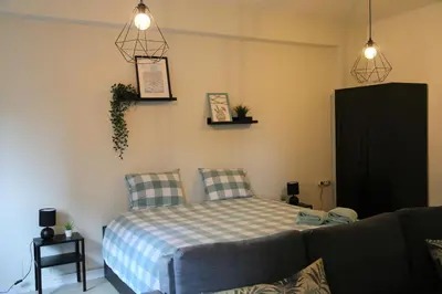 a bedroom with a bed and a couch at Bonsai Apartment I in Porto