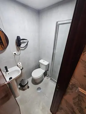 a white bathroom with a sink and a towel at Bonsai Apartment I in Porto