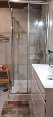 a shower with a glass door in a bathroom at Downtown Porto Spot - 2 bedroom Apartment in Porto