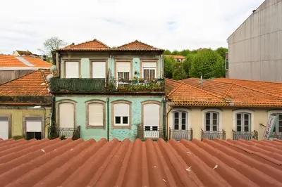 an old house with a balcony on top of a roof at Downtown Porto Spot - 2 bedroom Apartment in Porto