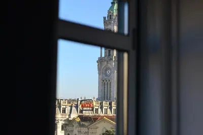 a view of a clock tower from a window at Downtown Porto Spot - 2 bedroom Apartment in Porto