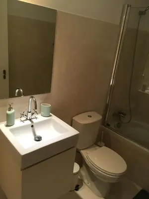 a bathroom with a toilet and a sink and a shower at Porta de São Bento in Porto
