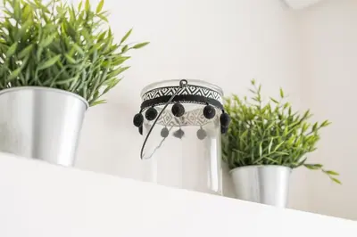 a figurine of an owl wearing a crown next to potted plants at GuestReady - Costa Cabral Guesthouse in Porto