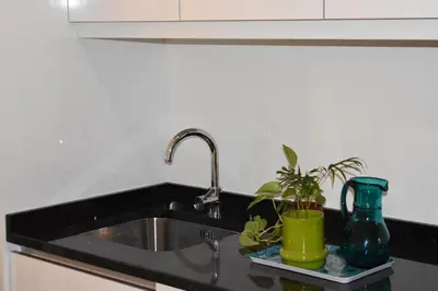 a kitchen sink with a green vase and a plant at Casa Barão Forrester in Porto