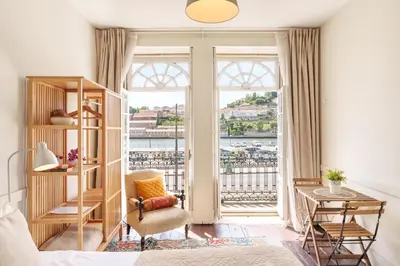 a desk with a lamp and a chair in a room at Porto Tile House in Porto