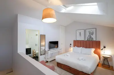a living room with a couch and a table and chairs at Douro Destilaria Residence by Porto City Hosts in Vila Nova de Gaia