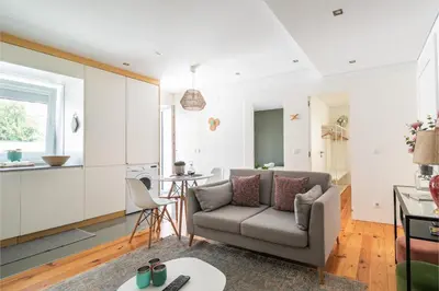 a living room with a couch and a kitchen at Porto Insight Apartments Campanhã in Porto