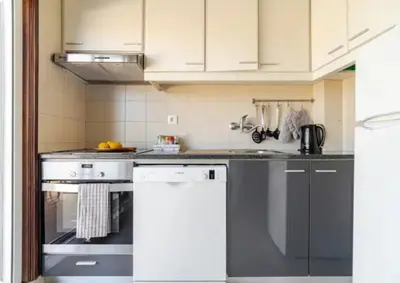 a kitchen with a stove and a counter top at Terraço da Boavista in Porto
