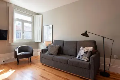 a living room with a couch and a chair at Cedofeita Deluxe Apartment 3F in Porto