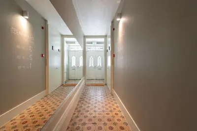 a hallway with doors and a tile floor at Cedofeita Deluxe Apartment 3B in Porto