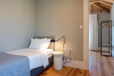 a bedroom with a bed and a lamp on a floor at Cedofeita Deluxe Apartment 3B in Porto