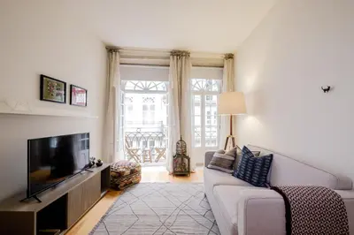 a living room with a couch and a tv at BOUTIQUE Rentals-Flores Plaza in city historical center in Porto