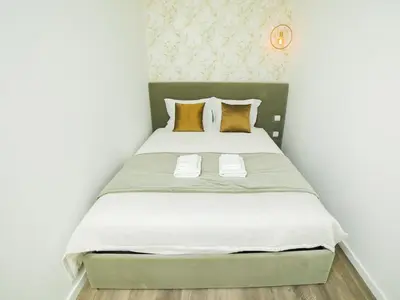 a bedroom with a large bed with yellow pillows at Angel Flats in Porto