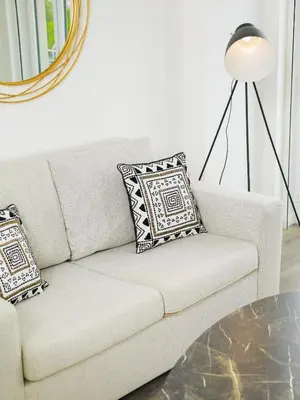 a white couch with pillows and a lamp in a living room at Angel Flat in Porto