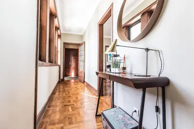 a hallway with a table and a mirror on the wall at YOUROPO - Santa Catarina in Porto