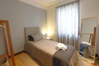 a bedroom with a bed and a large mirror at FLH Porto Spacious Flat in Porto