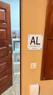 an al sign on the door of a refrigerator at Apartamento Lar doce Lar Porto in Vila Nova de Gaia