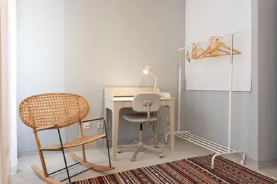 an office with a desk and a chair and a lamp at Marias River Apartment in Porto