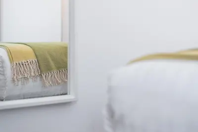 a beige and green blanket hanging on a window at Porto Belo Sao Bento Apartment in Porto