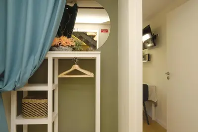 a room with a mirror and a shelf with a closet at Oporto Wall Apartments in Porto