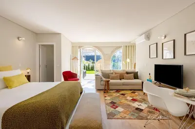 a bedroom with a bed and a living room at Boavista Garden Studio 183 in Porto
