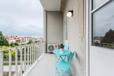 a small blue table on a balcony with a view at GuestReady - Bay Watch in Porto