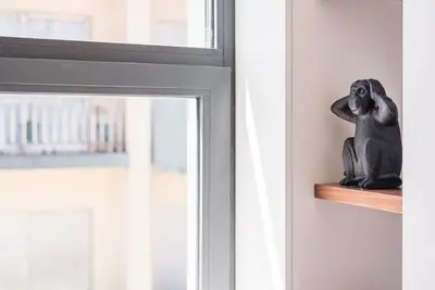 a statue of a monkey sitting on a window sill at GuestReady - Grit & Glam in Porto