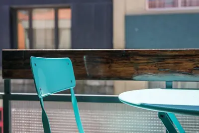 a blue chair sitting next to a table at GuestReady - Grit & Glam in Porto