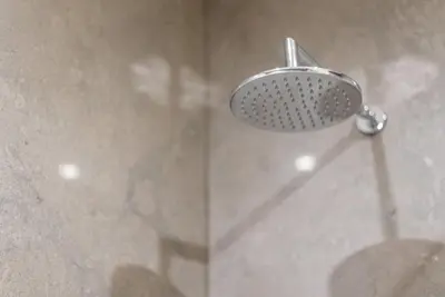 a shower with a shower head in a bathroom at GuestReady - Grit & Glam in Porto
