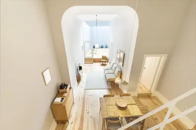 a kitchen and living room with a table and chairs at Tripas-Coração, Santa Teresa in Porto