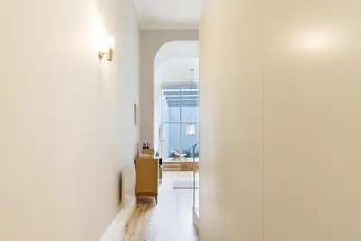 a hallway with white walls and an archway at Tripas-Coração, Santa Teresa in Porto