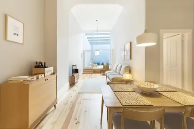 a living room with a table and a couch at Tripas-Coração, Santa Teresa in Porto
