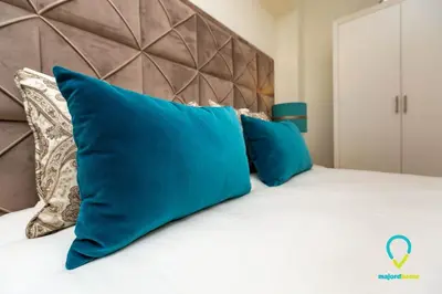 a bed with blue pillows on top of it at Camilo Apartment in Porto