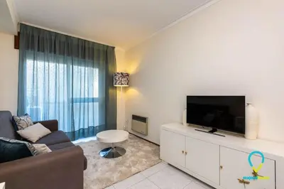 a living room with a couch and a flat screen tv at Camilo Apartment in Porto