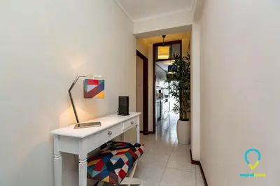 a white desk with a lamp on it in a hallway at Camilo Apartment in Porto