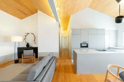 a living room with a couch and a kitchen at Mouzinho Village River in Porto