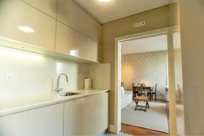 a kitchen with a sink and a dining room at Cardosas Square Apartments by Porto City Hosts in Porto