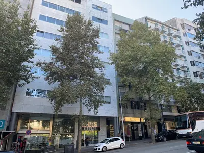 a white car parked in front of a tall building at Ninon- Premium Trindade by Porto City Hosts in Porto