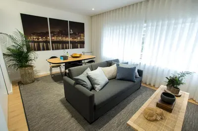 a living room with a couch and a table at Ninon- Premium Trindade by Porto City Hosts in Porto