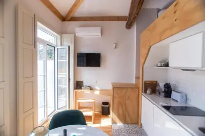 a small kitchen with a table and a window at Picasso Suites Porto by PCH in Porto