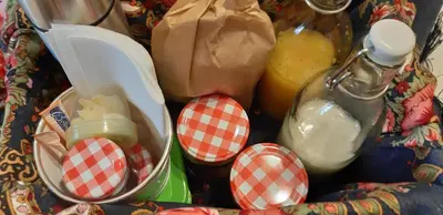 a table with some food and a bottle of juice at Lemago Porto Apartments - Sé in Porto