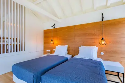 two beds sitting next to each other in a room at Lemago Porto Apartments - Sé in Porto