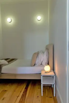 a bed in a room with a lamp on a table at Santa Catarina Views by Porto City Hosts in Porto